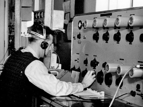 operator wearing headphone and seated in front of the large TRF DF console at Musick Point
